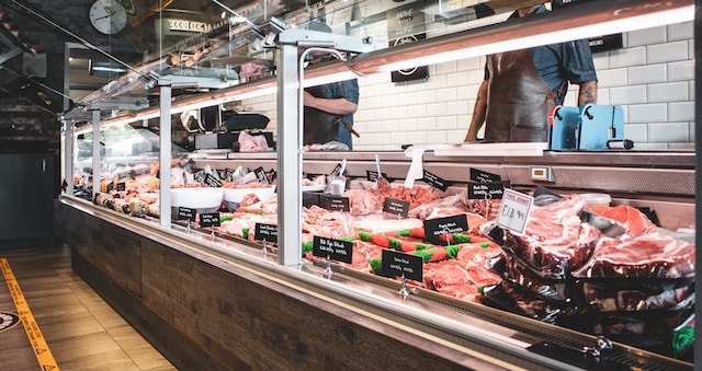 butcher shop counter with various meats on display